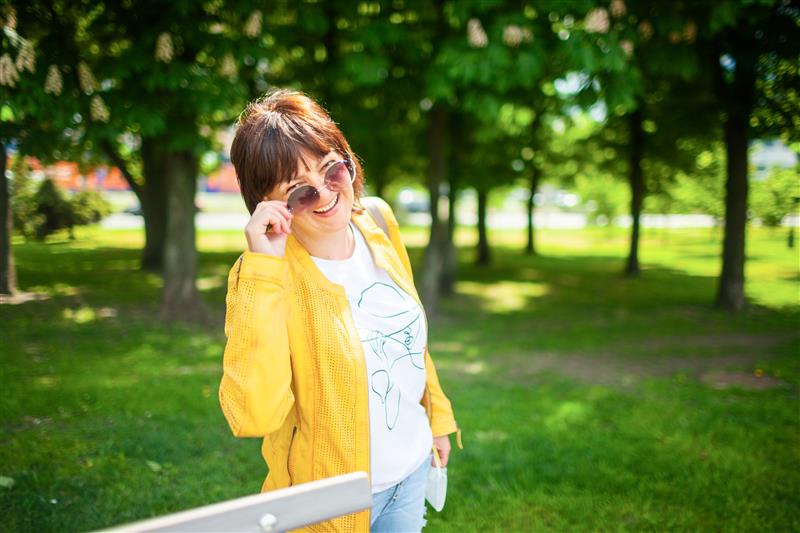 Close-up portrait of a young beautiful blonde woman against the background of a winter snow-covered forest.